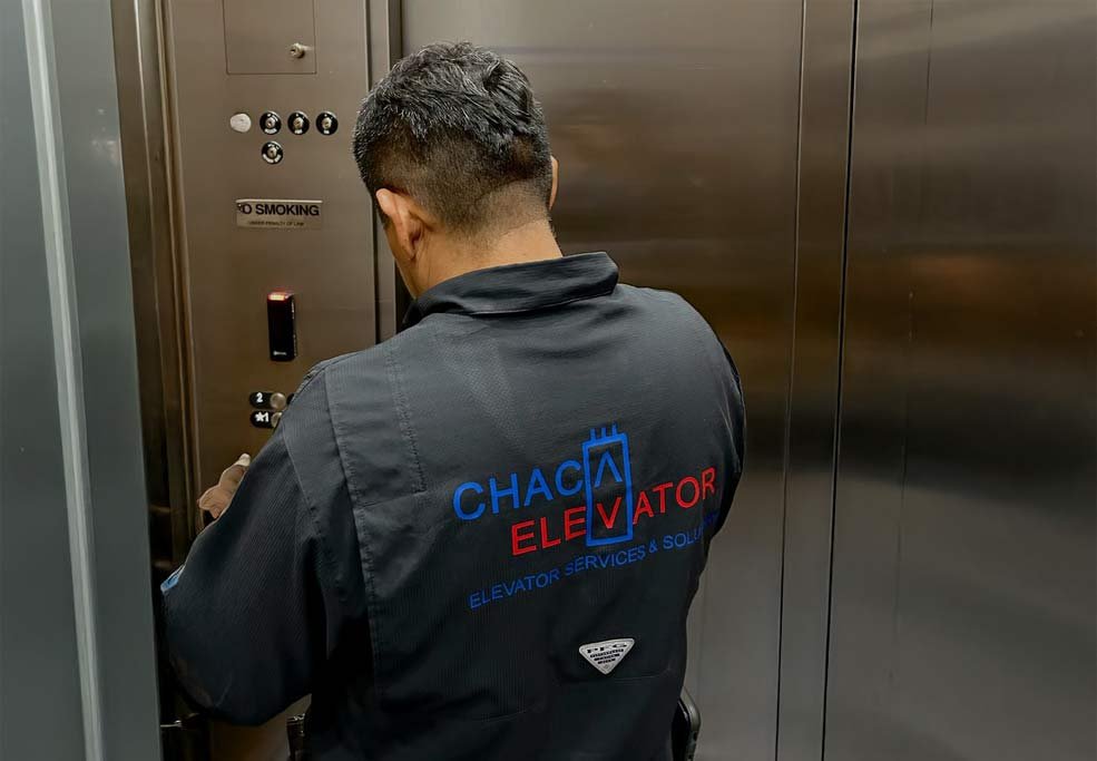 Chaca Elevator technicians performing maintenance on an elevator control system